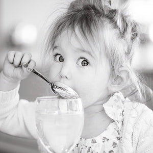 Toddler eating ice cream looking at camera