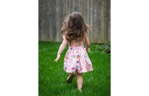 Back view of birthday dress in cakes print