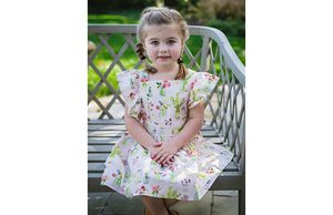 Toddler wearing vintage inspired dress in pink plants