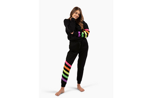 Model wearing matching black activewear loungewear set with neon stripes