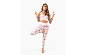 Girls modeling activewear set in sunset tie dye: pastel leggings and sports bra set
