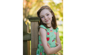 Girl modeling ruffle sleeve dress in vegetable print